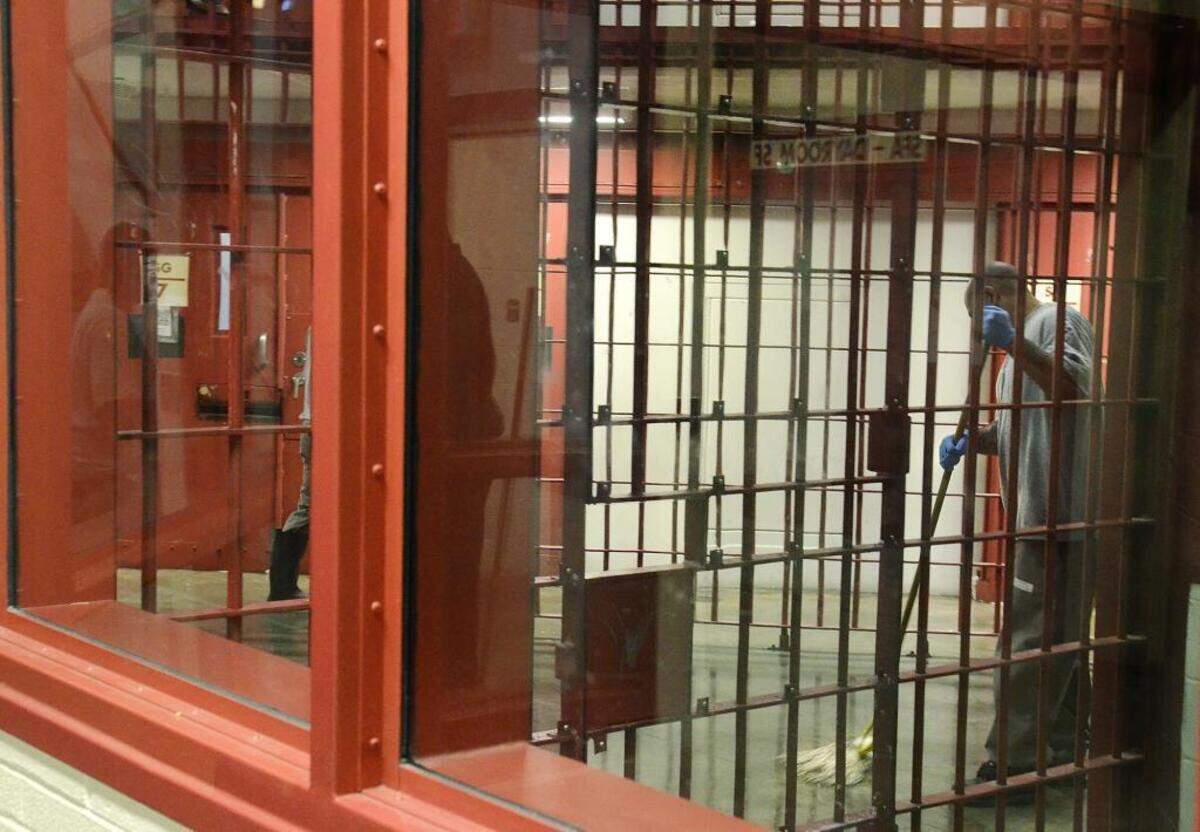 An inmate mops the floor inside a solitary confinement unit at Lanesboro Correctional Institution.