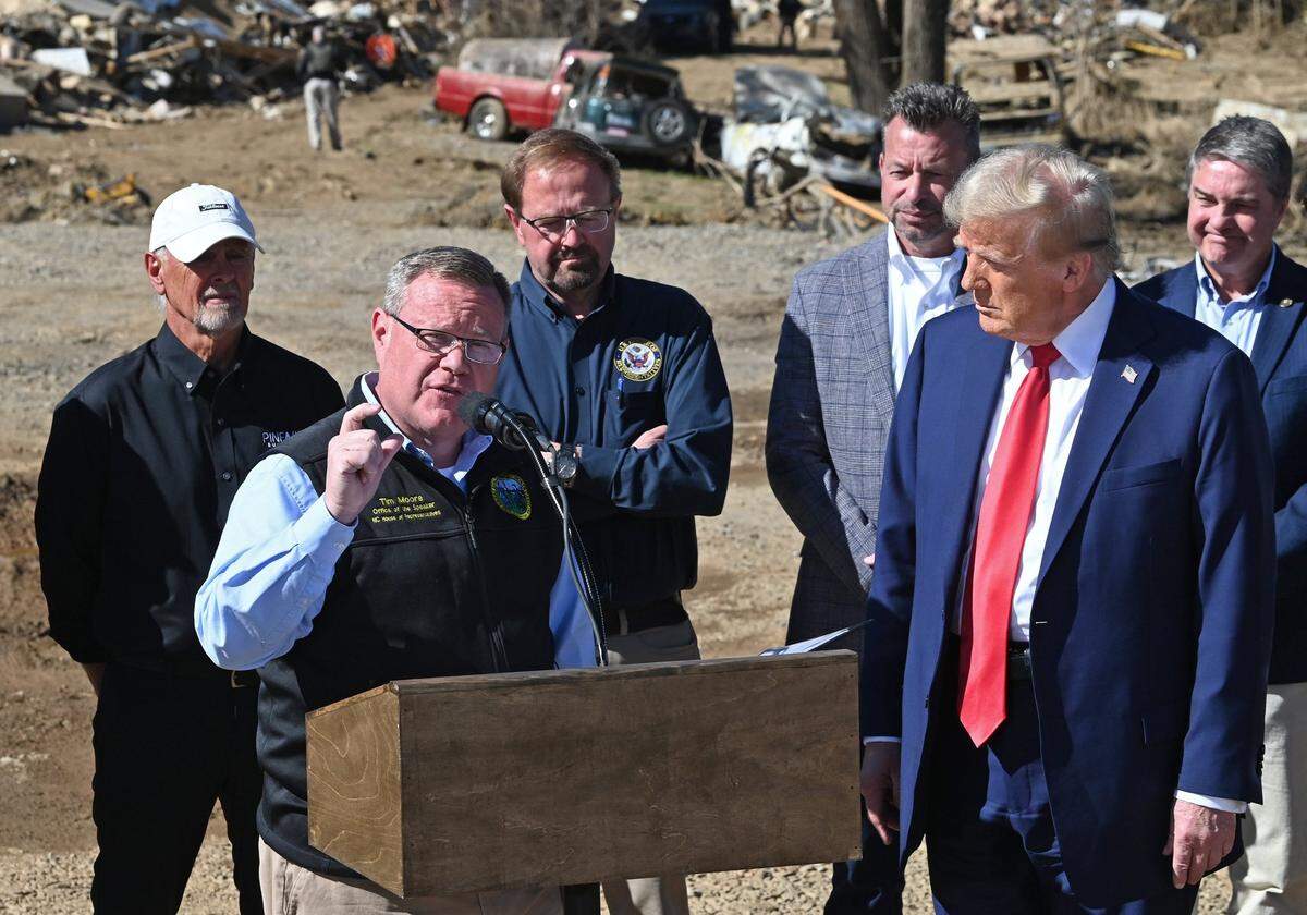 Tim Moore, the speaker of North Carolina House of Representatives, center, speaks as former President Donald J. Trump, right, listens in Swannanoa, NC on Monday, October 21, 2024.