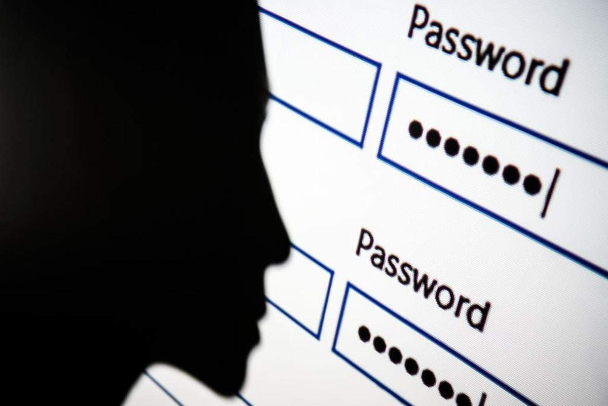 LONDON, ENGLAND - AUGUST 09: In this photo illustration, A woman is silhouetted against a projection of a password log-in dialog box on August 09, 2017 in London, England. (Photo by Leon Neal/Getty Images)