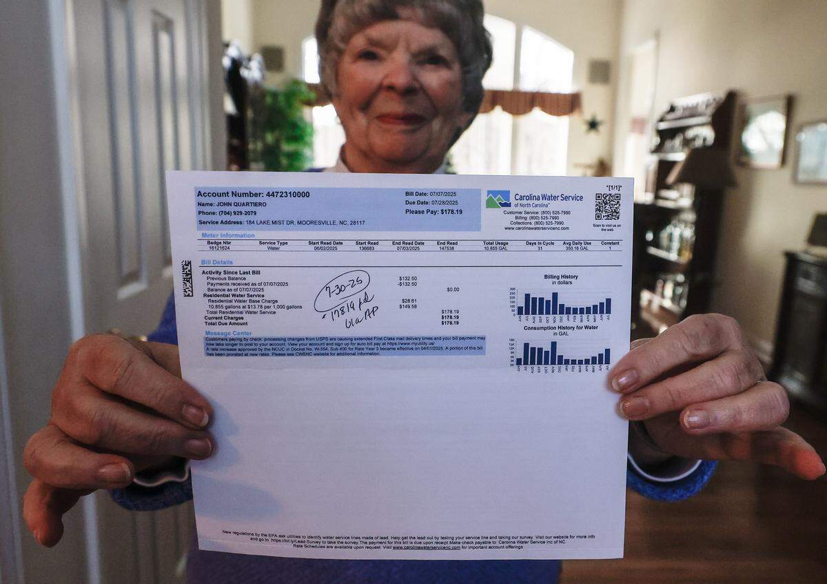 Lake-Norman resident Susan Quartiero holds a copy of a monthly water bill in the amount of $178.19 from Carolina Water Service, a private, investor-owned utility company.