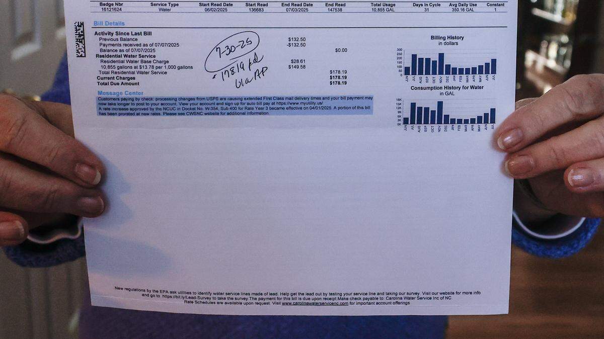 Lake-Norman resident Susan Quartiero holds a copy of a monthly water bill in the amount of $178.19 from Carolina Water Service. Carolina Water seeks to charge higher water and sewer rates.