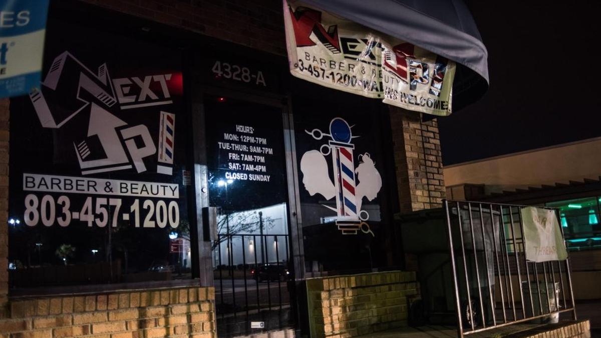 Headlights of a passing vehicle on Fort Jackson Boulevard illuminate Next Up Barber & Beauty on Saturday night in Columbia. One of two masked men who allegedly robbed patrons at the shop Friday night was shot and killed when two of the patrons pulled weapons and shot back, Columbia police said. January 23, 2016
