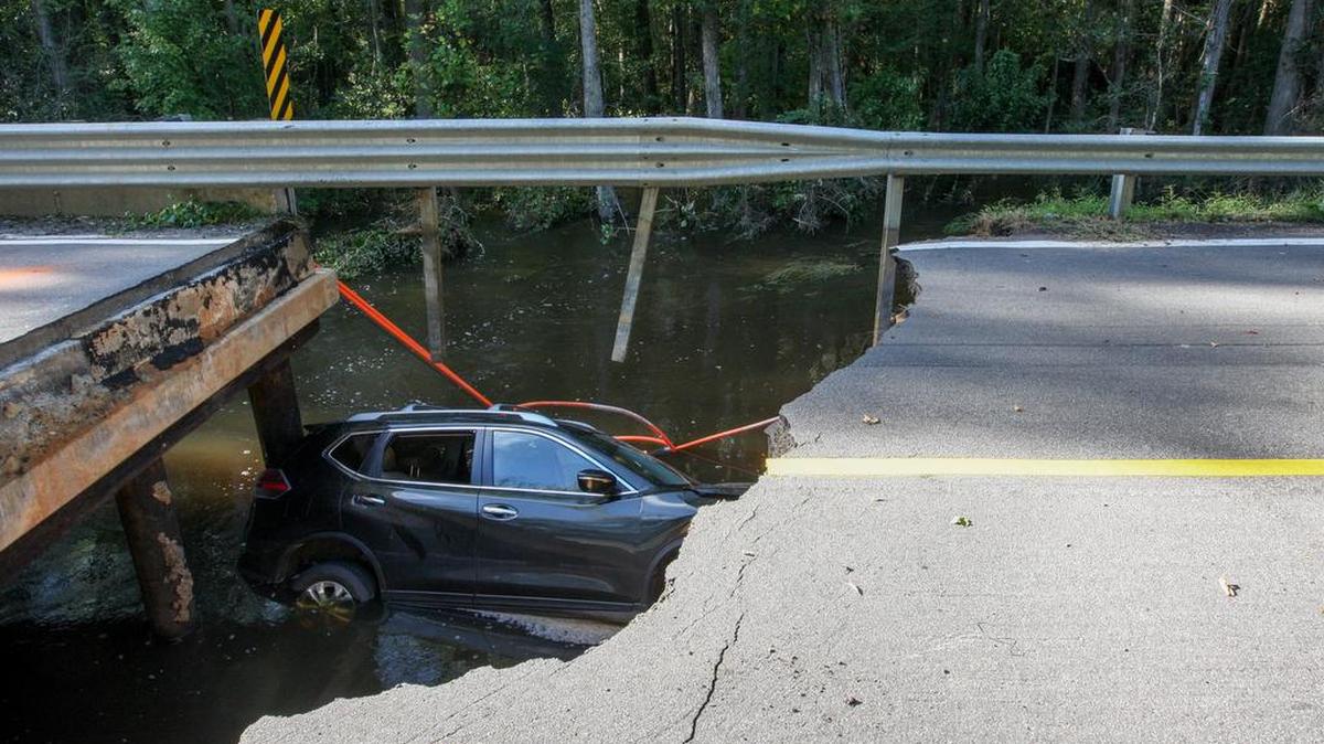 A car lies in Myers Creek in Hopkins where the bridge on Lower Richland Boulevard collapsed.