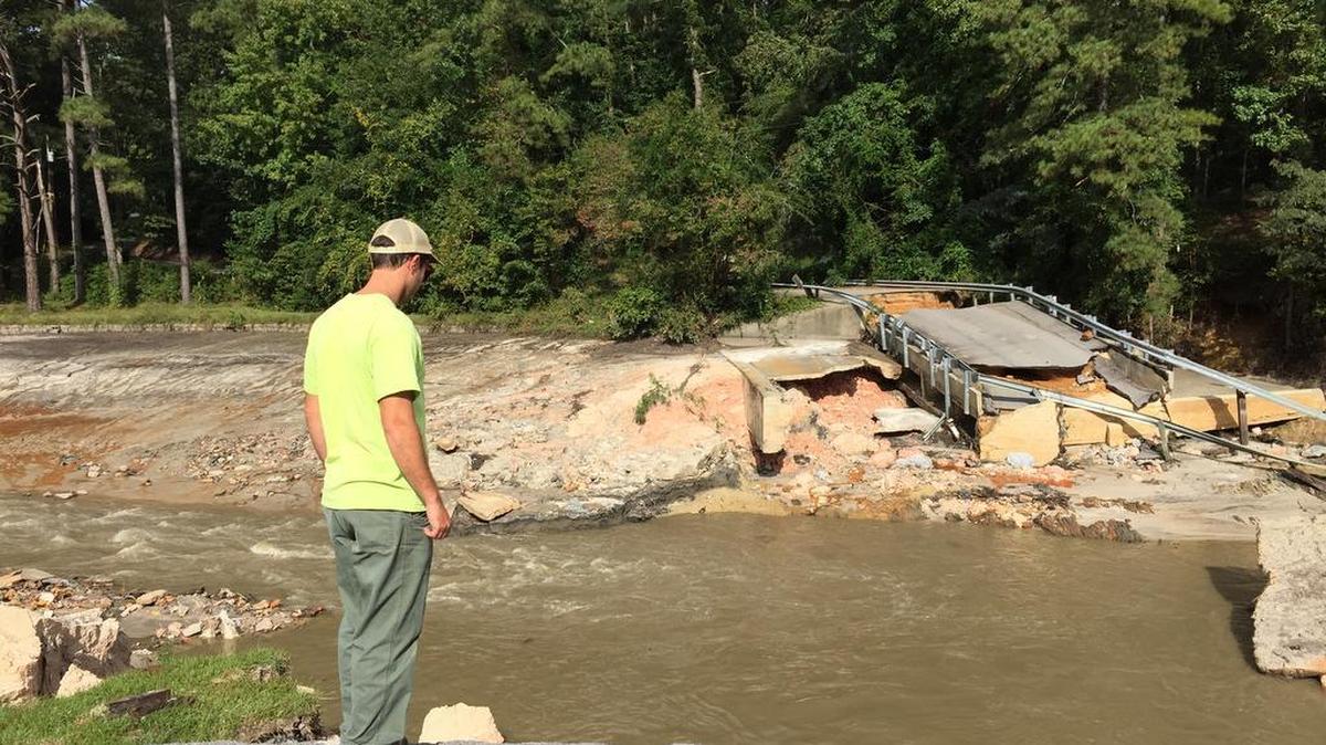 Gills Creek Watershed Association director Erich Miarka surveys the broken dam at Cary Lake in the Columbia area. State regulators want more money to inspect dams