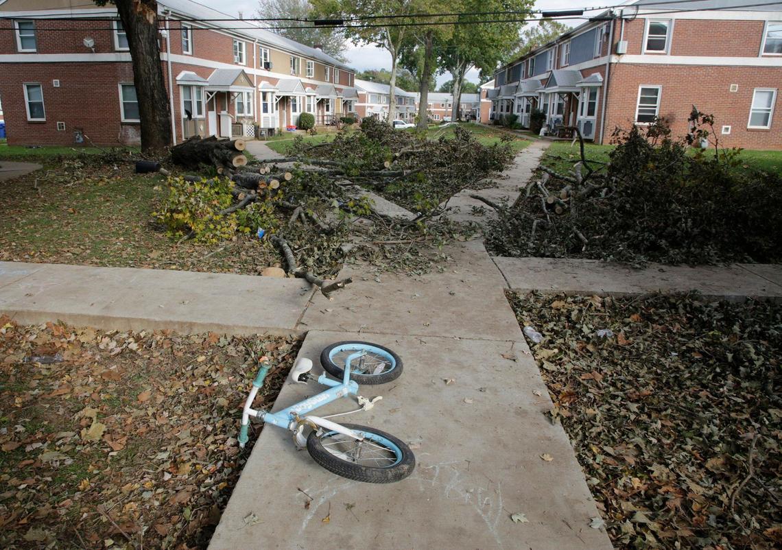 A child’s bicycle lays near fallen tree branches at Pisgah View apartments in Asheville, NC on Thursday.