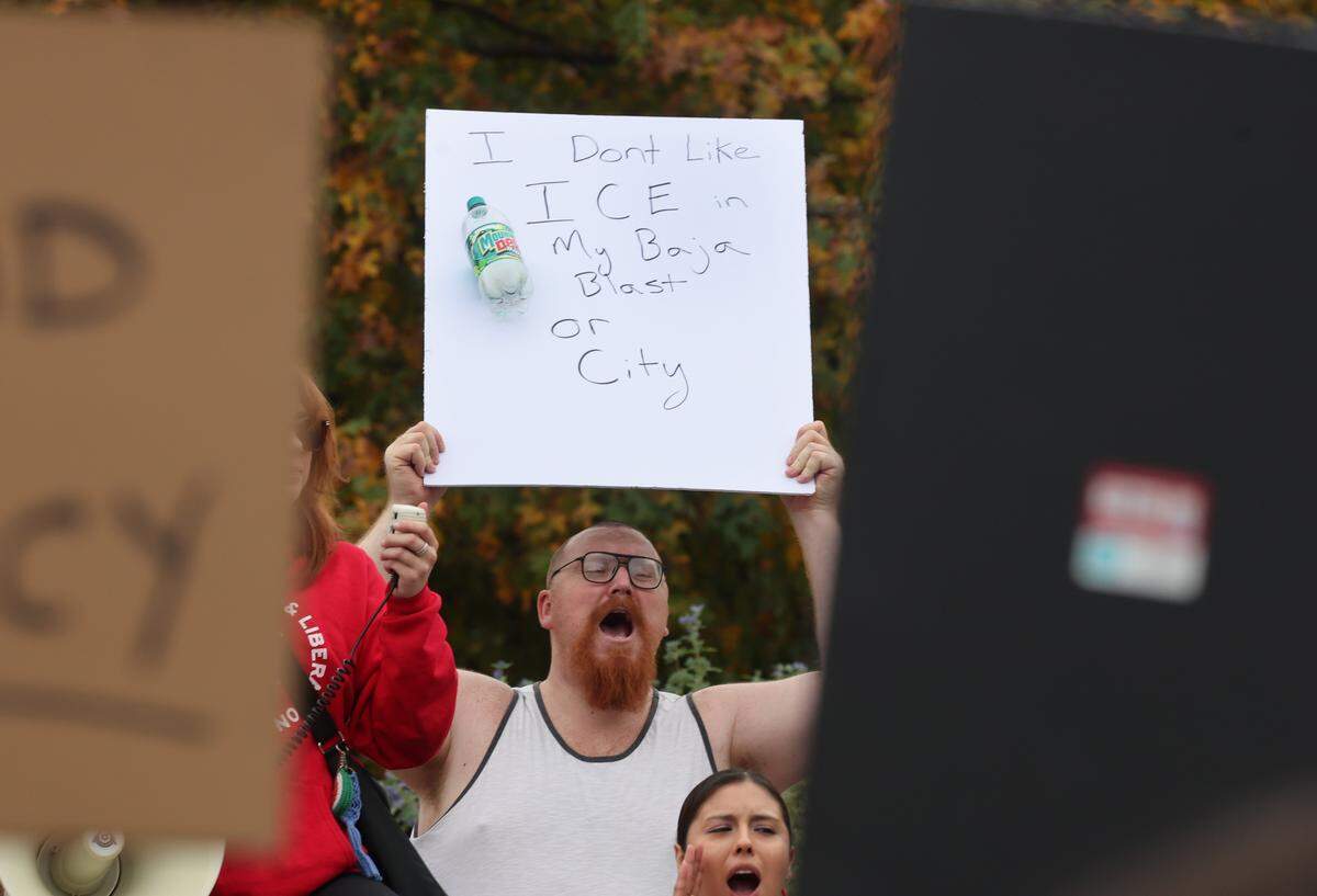 A protester yells while listening to a speaker Saturday, Nov. 15, 2025 at the No Border Patrol protest in uptown Charlotte.