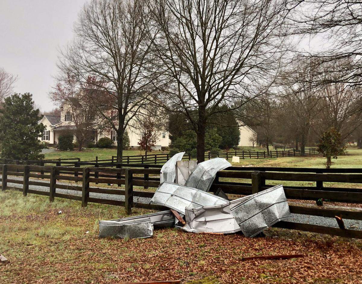 Aluminum siding is tangled with wooden fencing after severe wind passed through the Friendly Baptist Church area in Union County on Wednesday.