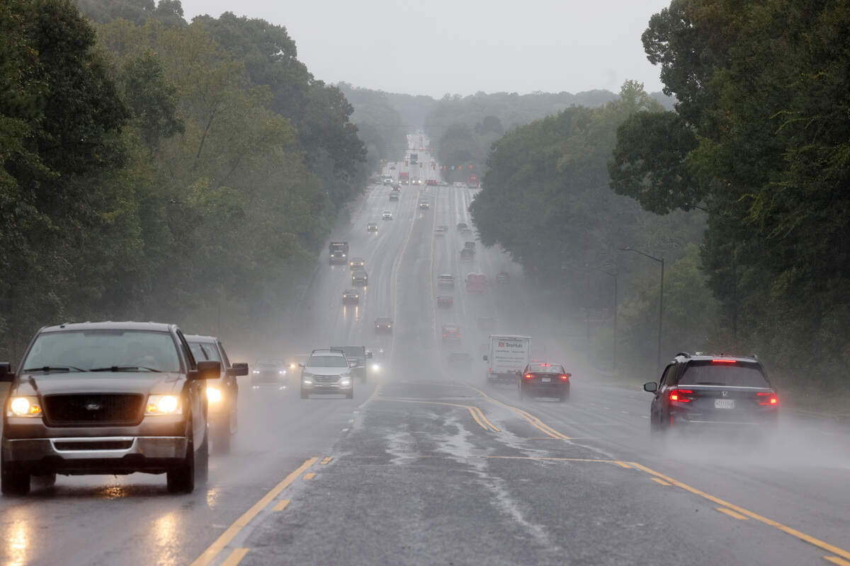 Traffic flows down Celanese Road Thursday as heavy rain falls.