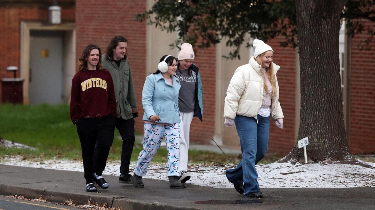 Winthrop University students walk on campus near freshly-fallen snow and sleet