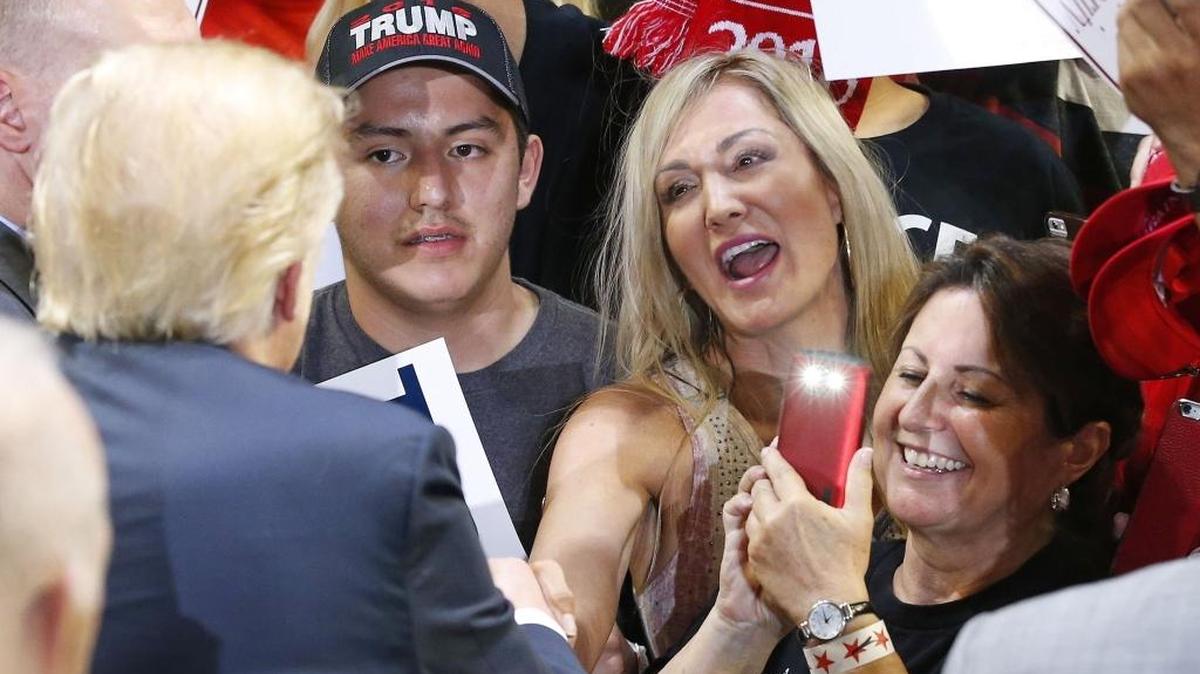 Donald Trump signs autographs for supporters after speaking at a rally in Phoenix last week.