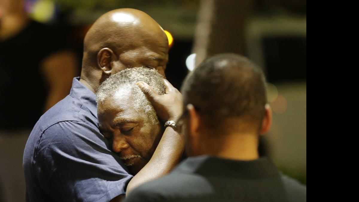 
Worshippers embrace following a group prayer Wednesday across the street from the scene of a shooting at Emanuel AME Church in Charleston. 
