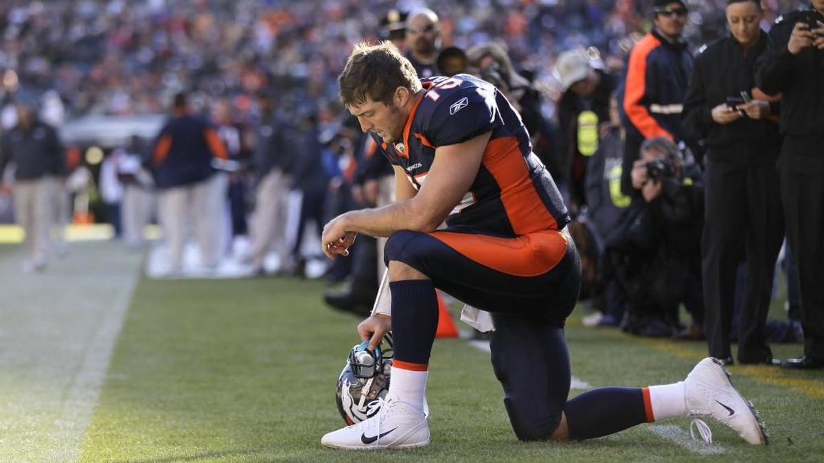 Then-Denver Broncos quarterback Tim Tebow prays in the end zone before a game in 2011.