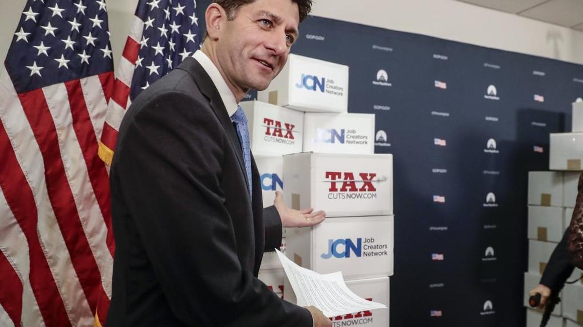 House Speaker Paul Ryan, R-Wis., points to boxes of petitions supporting the Republican tax reform bill.