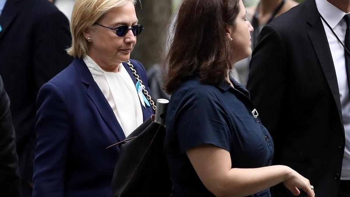 Hillary Clinton arrives with an unidentified woman at the September 11 Commemoration Ceremony in New York on Sunday.