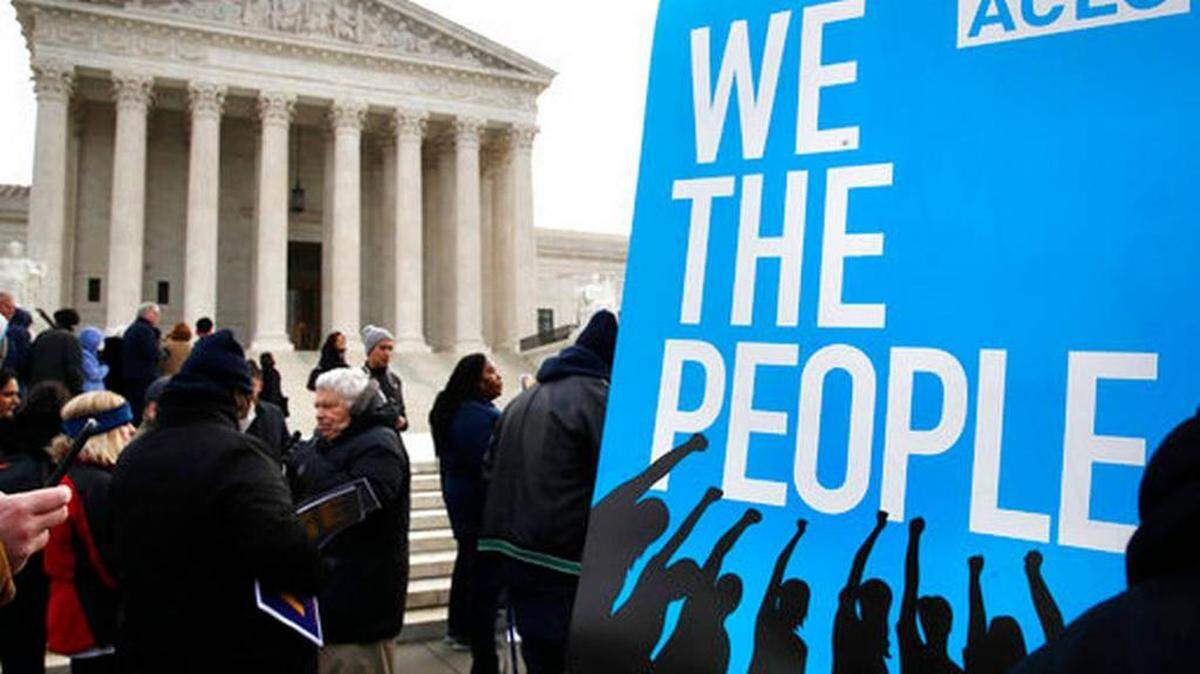 People rally in January outside of the Supreme Court in opposition to Ohio's voter roll purges.