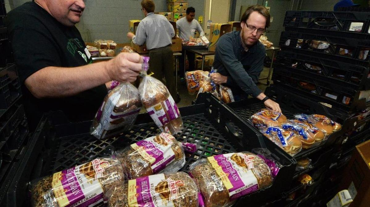 Volunteers sort and pack bread at Second Harvest Food Bank in Charlotte last month.