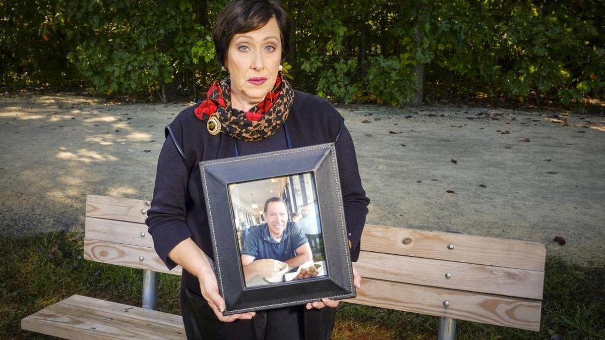 
Fran Wolberg poses for a portrait with a photo of her late husband, Mark Wolberg, in Winston-Salem this month.
