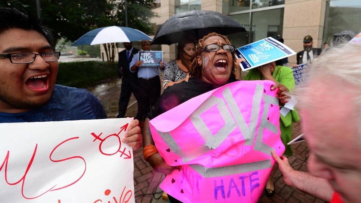 People with opposing views face-off during the N.C. Values Coalition protest outside the Charlotte-Mecklenburg Government Center in Charlotte on Tuesday, Aug. 9.