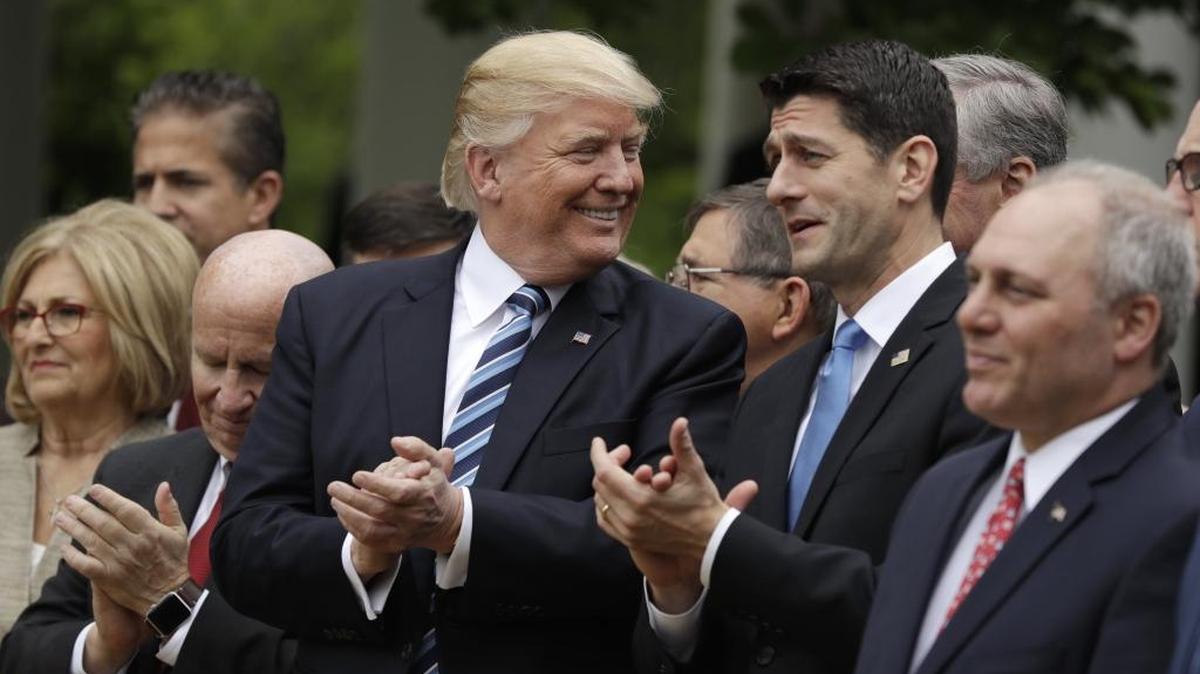President Donald Trump talks with House Speaker Paul Ryan in May after the House pushed through a health care bill.