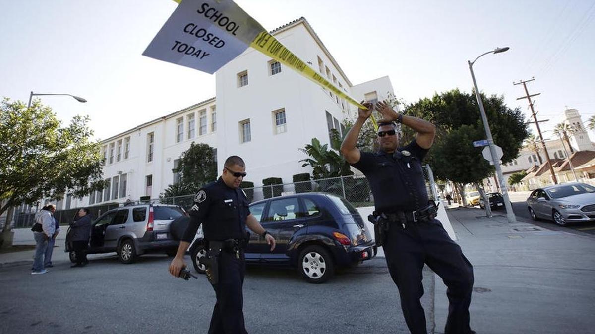 L.A. Unified police officers leave Breed Street Elementary after conducting a safety check.