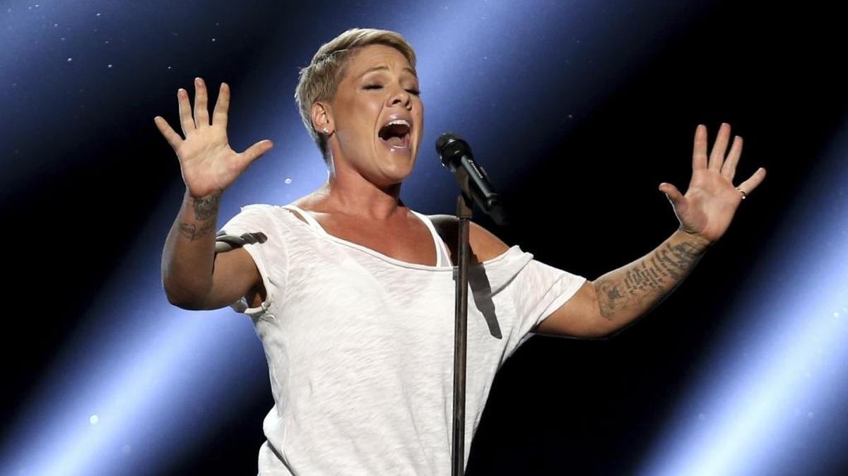 Pink, shown singing at the Grammys this week, will sing the national anthem at the Super Bowl on Sunday.