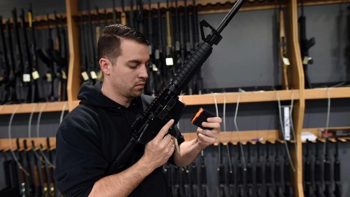 An employee places an empty magazine in an assault-style rifle at the RTSP shooting range in Randolph, New Jersey on Wednesday.