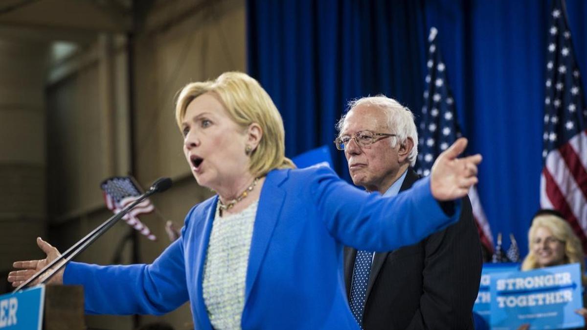 Hillary Clinton speaks in New Hampshire Tuesday as Bernie Sanders looks on. Sanders endorsed her Tuesday, finally.