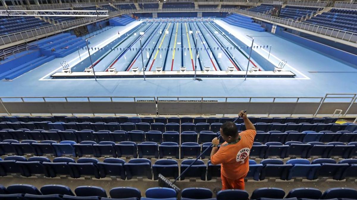 A worker sweeps at the Olympics Aquatics Stadium as preparations continue for the Rio Olympics.