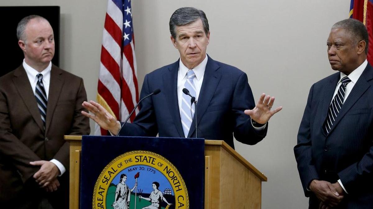 North Carolina Gov. Roy Cooper, center, proposes a compromise on repealing HB2 on Tuesday. House Democratic leader Darren Jackson is at left; Senate Democratic leader Dan Blue is at right.