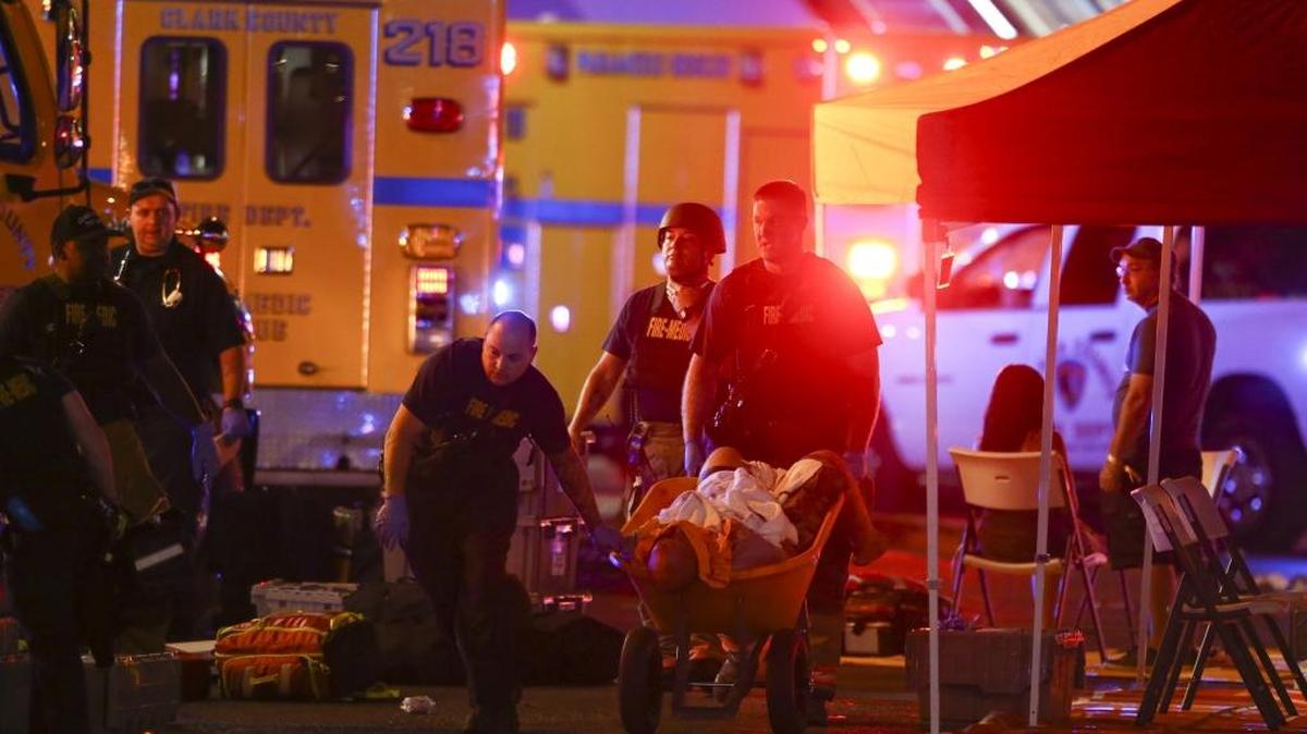 A wounded person is transported away from a shooting in which 50 were killed and more than 400 injured Sunday in Las Vegas.