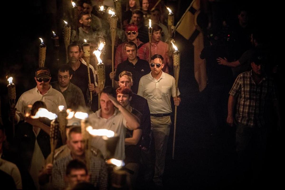 Protesters carrying torches marched in a parade through the University of Virginia campus.