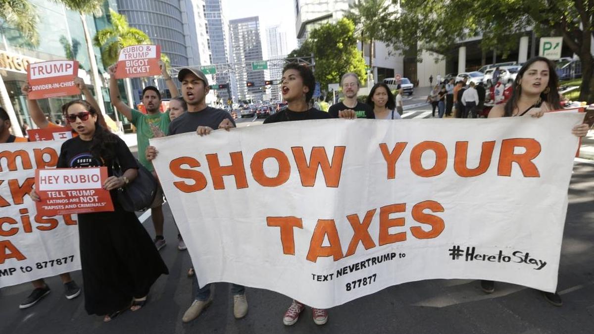 Miami protesters want Donald Trump to release his tax returns. Trump might not have paid federal income taxes for 18 years.
