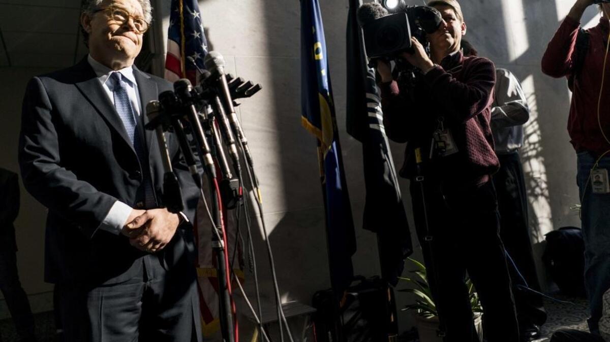 Al Franken speaks to journalists outside his Capitol Hill office last month about sexual harassment allegations against him.