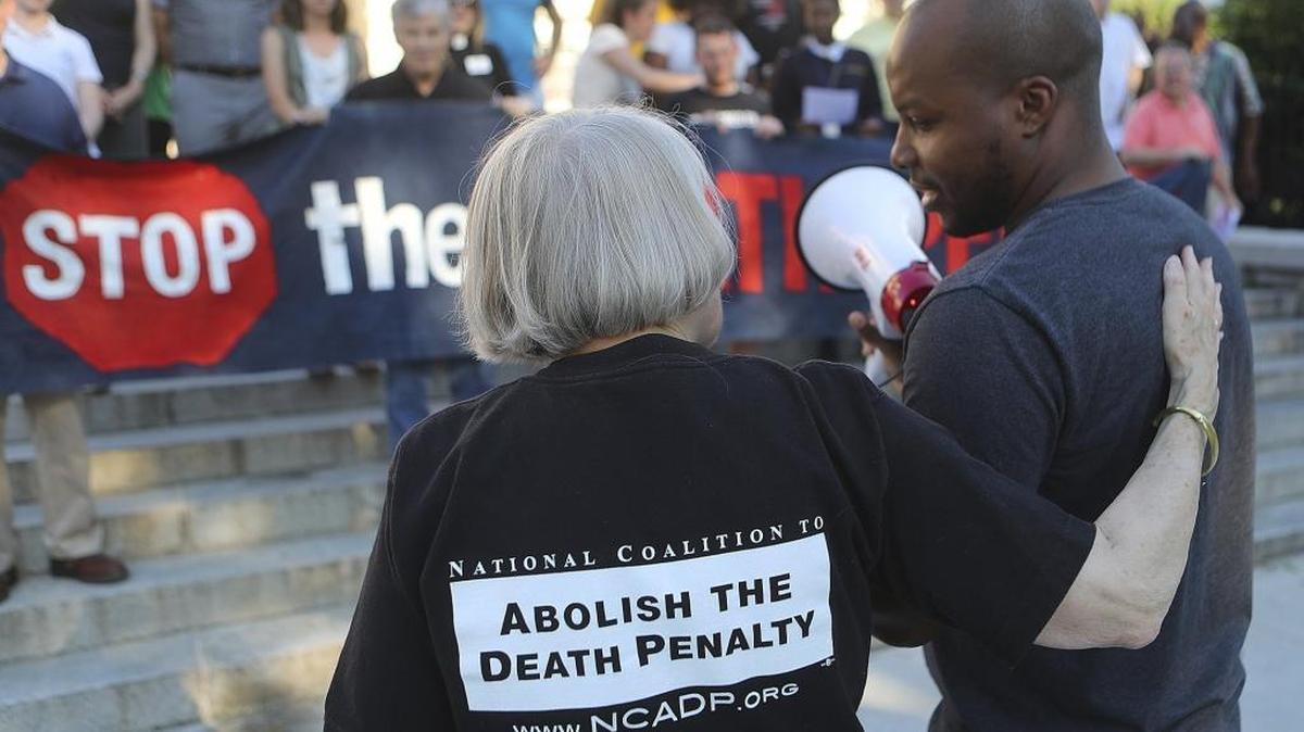 Peggy Hendrix and Mustafa Mahdi speak out against the death penalty while opponents protest the planned execution of J.W. Ledford Jr. in another Georgia case earlier this year.