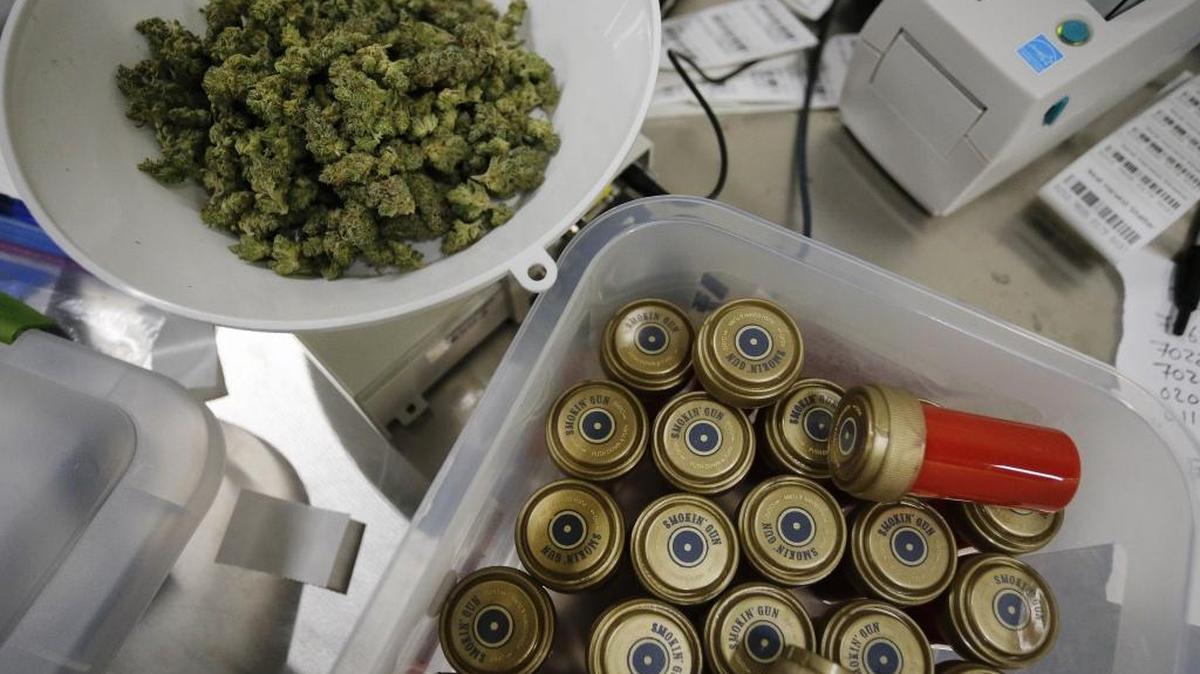 Marijuana sits next to containers designed to look like shotgun shells at a Colorado dispensary.