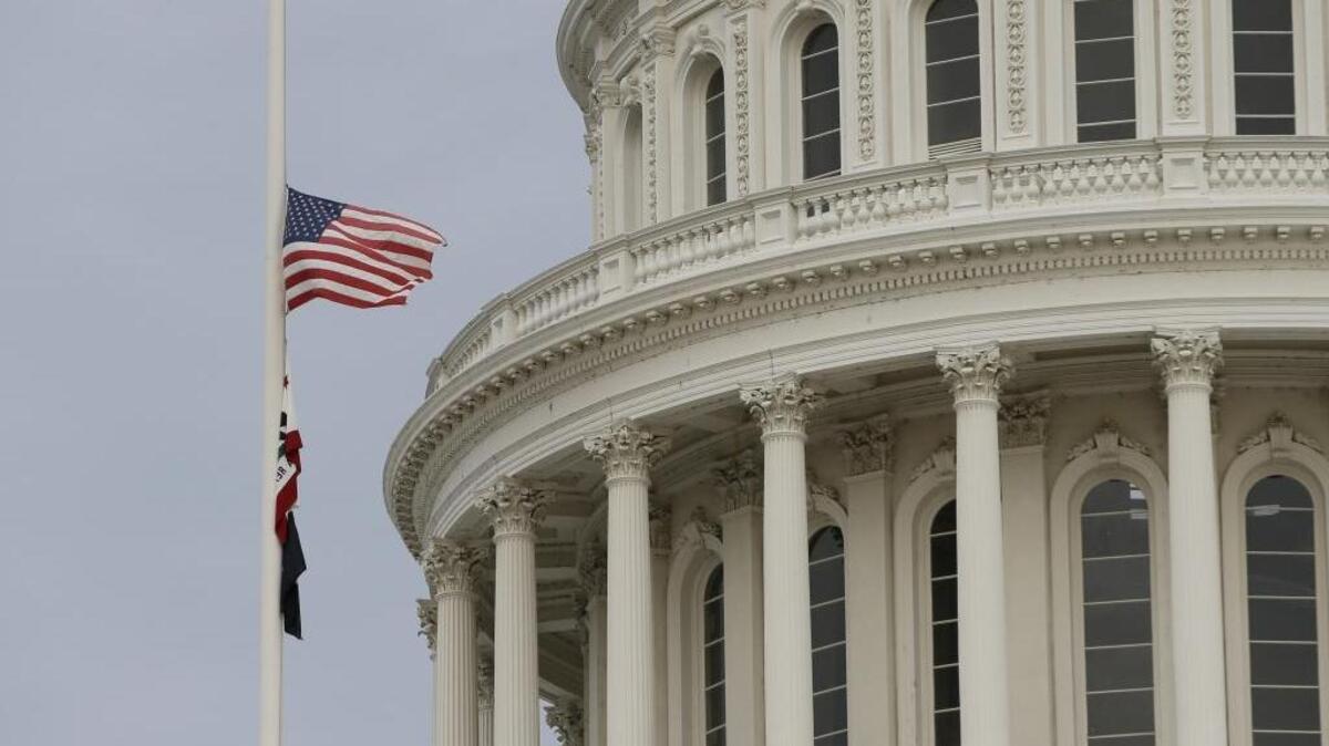 Flags fly at half staff at the Capitol, in Sacramento, Calif., to honor the victims of a mass shooting in San Bernardino, Calif., Wednesday.