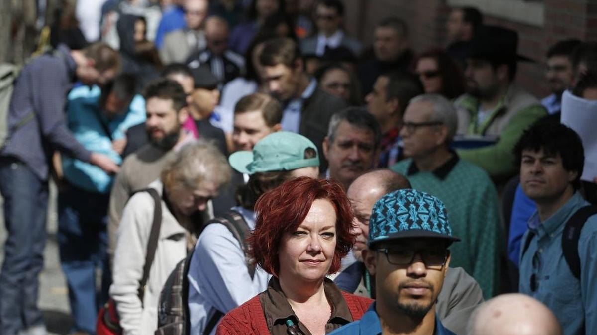 Job seekers line up by the hundreds to attend a 2014 job fair hosted by Open Vape, a vaporizer company, in Denver.