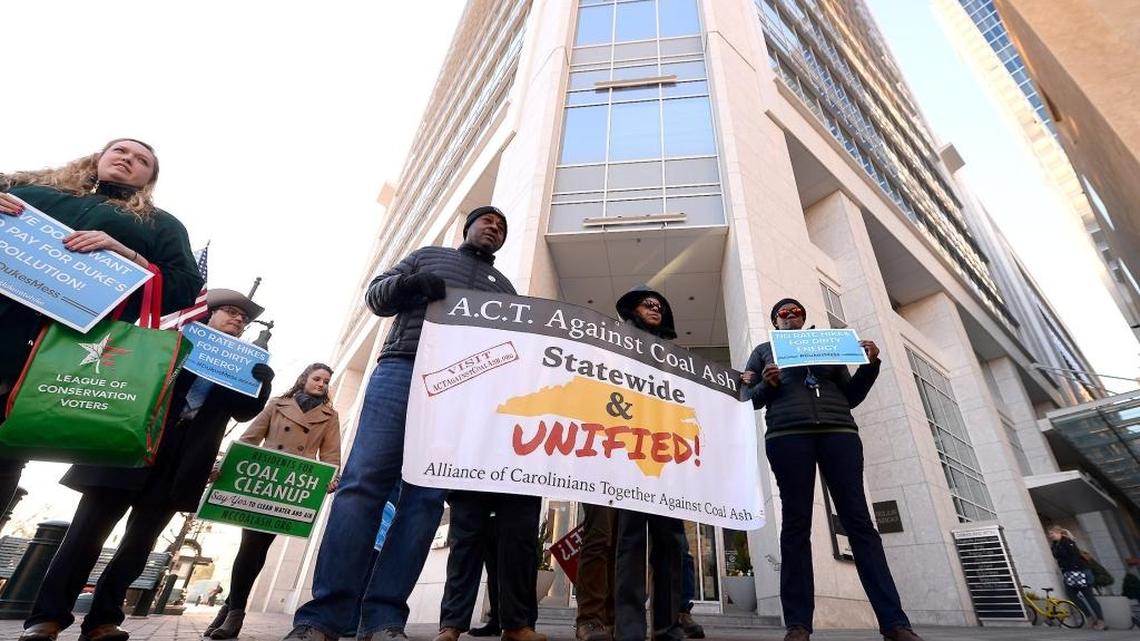 Environmentalists and others gather outside the Duke Energy headquarters on Tuesday.