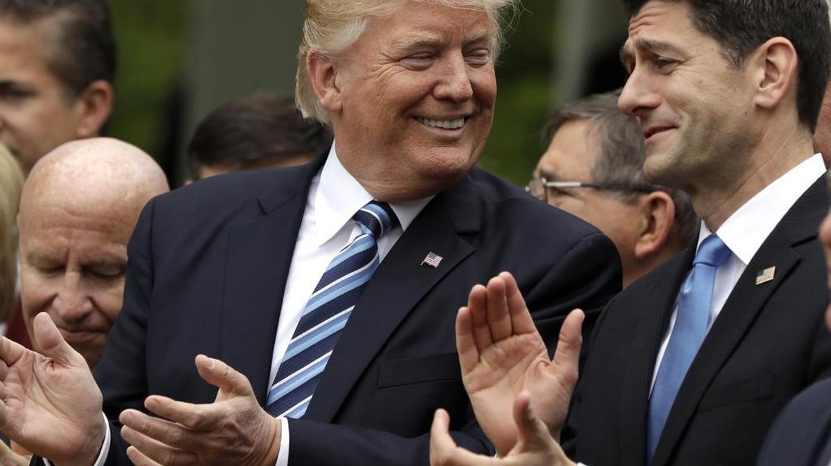 Donald Trump and House Speaker Paul Ryan celebrate passage of the health care bill Thursday at the White House.