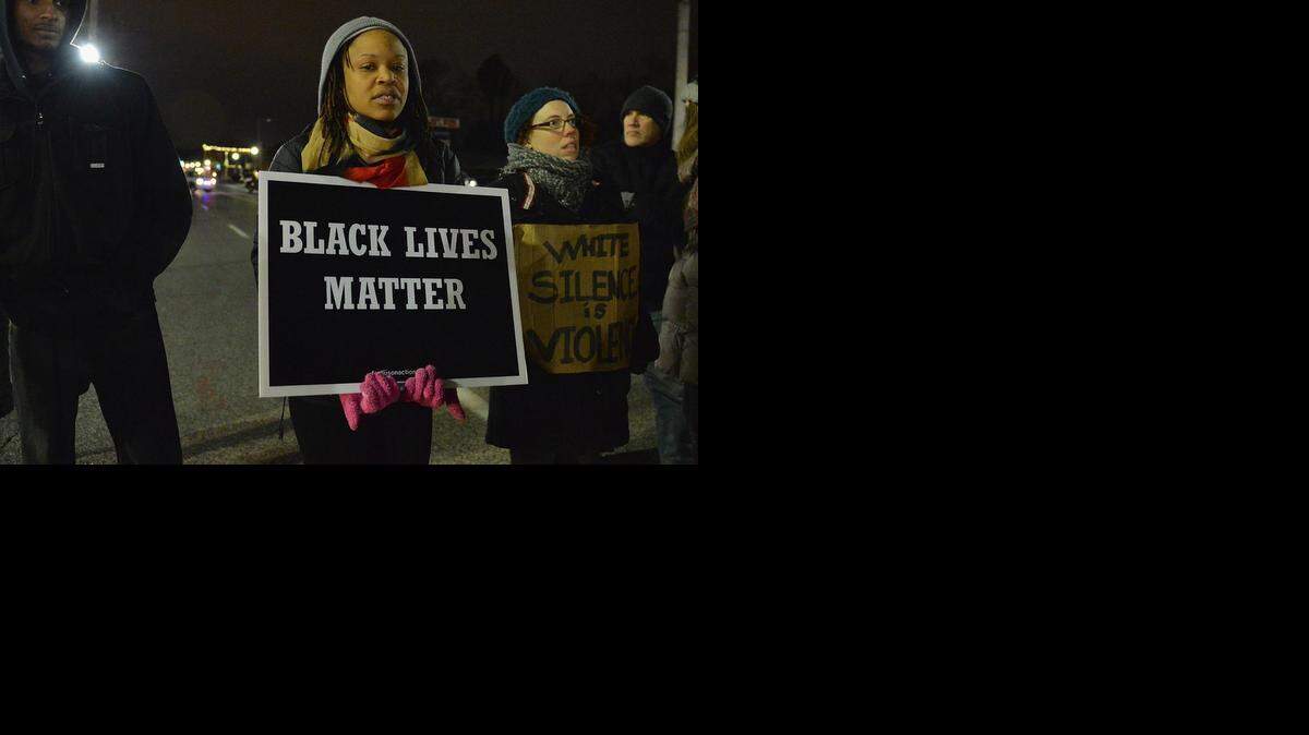 
Protestors demonstrate outside the Ferguson Police Department.
