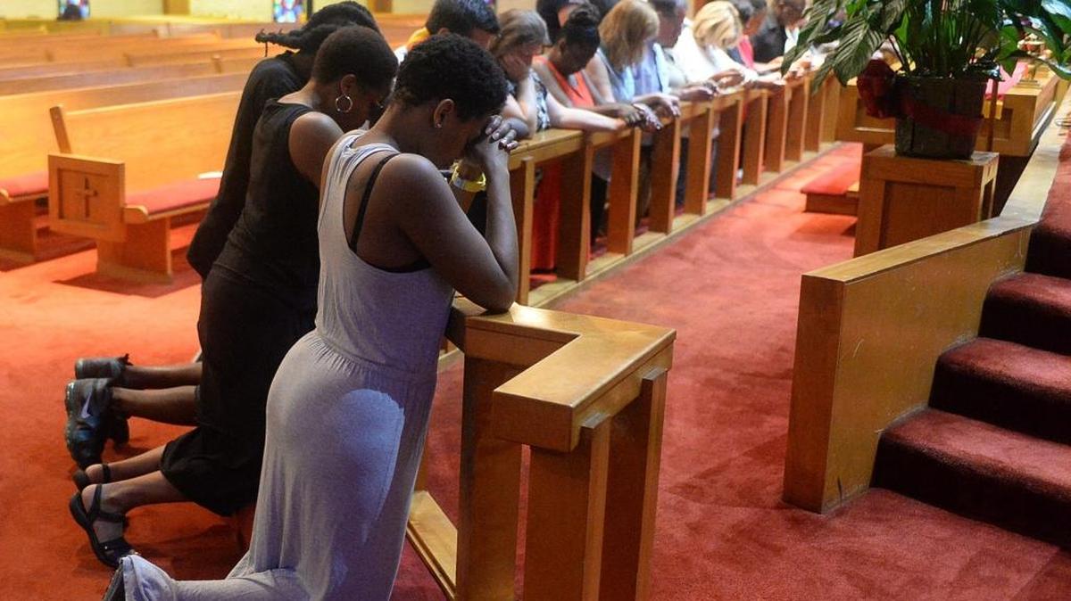 
People pray at Little Rock A.M.E. Zion Church after a mistrial was declared Aug. 21 at the Randall Kerrick trial. 
