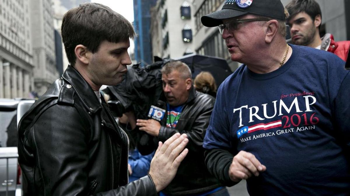 A Donald Trump supporter speaks with a demonstrator in New York after the election.
