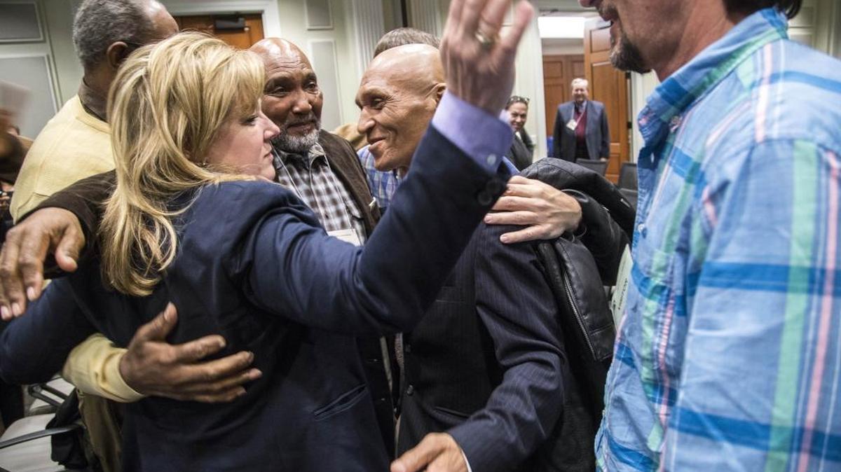 Attorney Christine Mumma gets hugs from supporters, including people she has helped exonerate, following a misconduct hearing Thursday in Raleigh.
