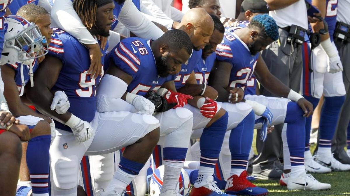 Buffalo Bills players kneel during the national anthem prior to their game against the Denver Broncos on Sunday.
