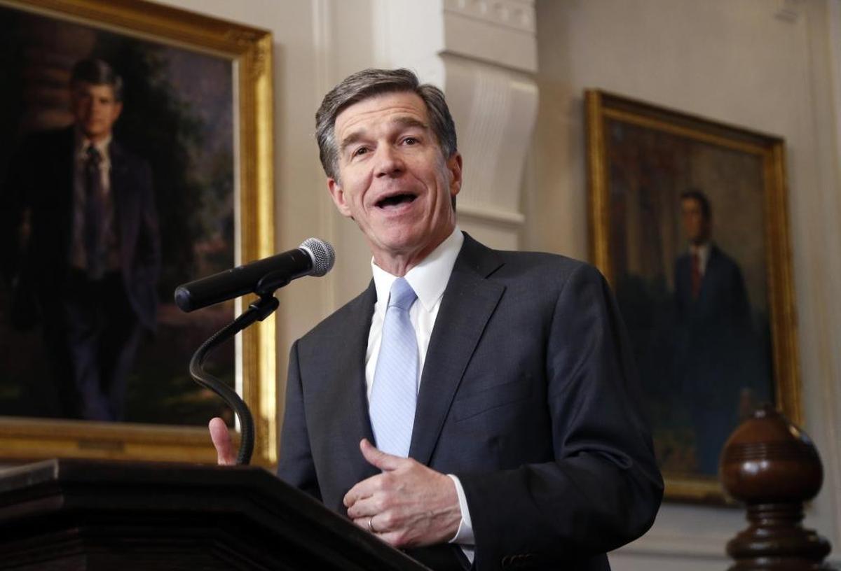 North Carolina Gov. Roy Cooper announces in March that he signed a HB142, a compromise replacement bill for HB2.