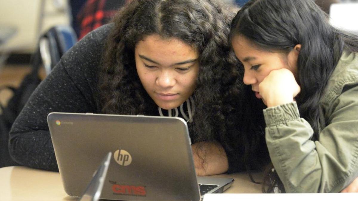 Tyliyah Manning, left, and Anisha Sunuwar work on a computer at Eastway Middle in February.