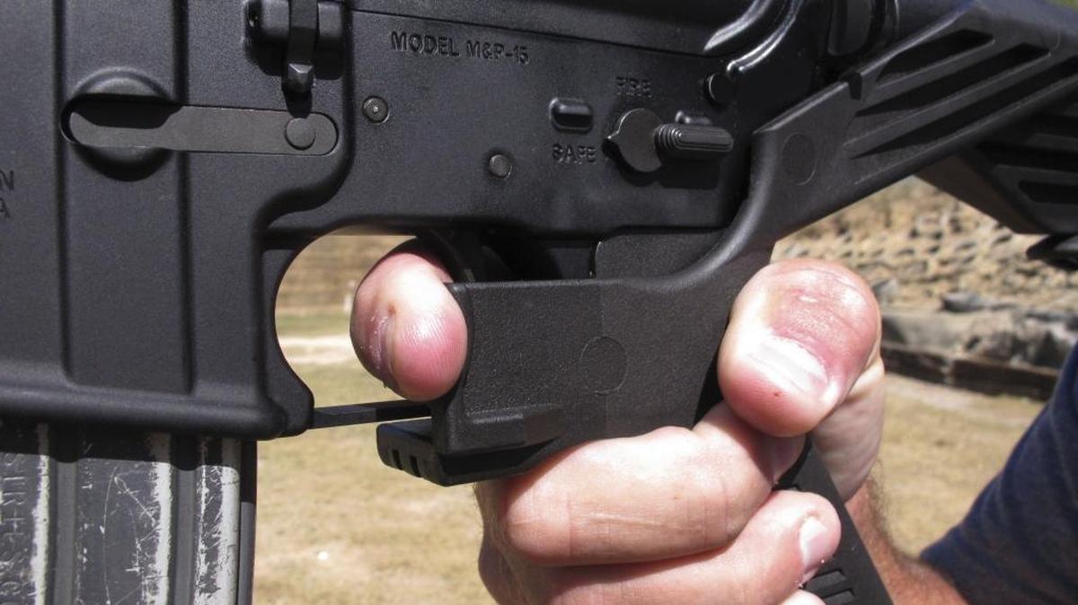 Instructor Frankie McRae demonstrates the grip on an AR-15 rifle fitted with a bump stock at his club in Bunnlevel, N.C.