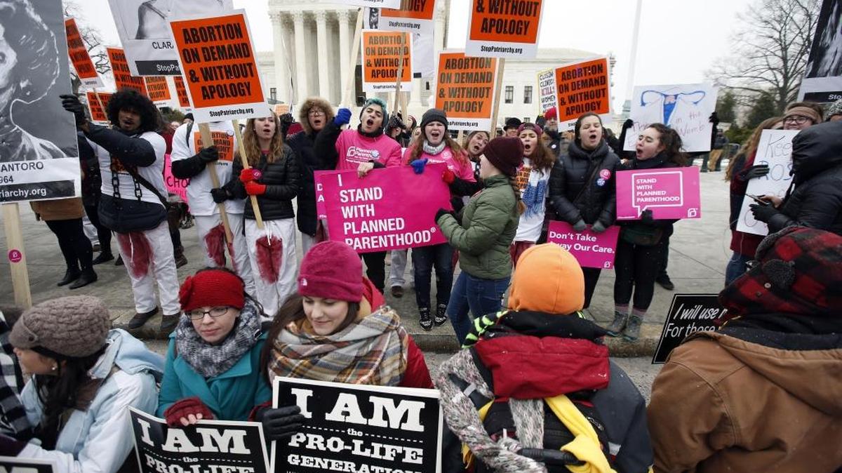 Protesters on each side of the issue rally at a march at the Supreme Court last month.