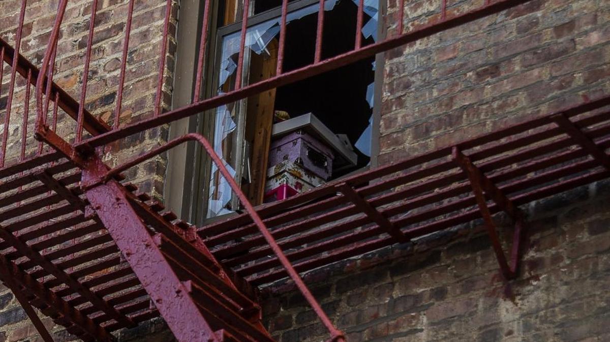 Boxes are seen through a broken window near a fire escape on the back of the building where more than 10 people died last week in the Bronx borough of New York.