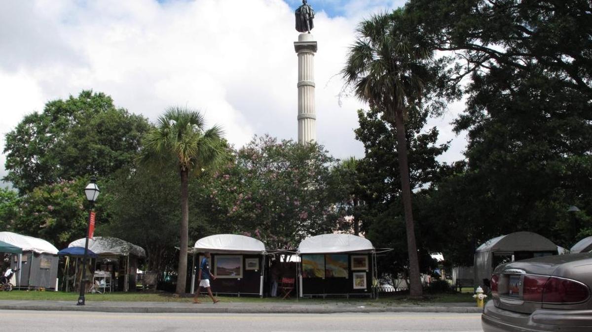 A statue of slavery proponent John C. Calhoun stands tall over a park in Charleston.
